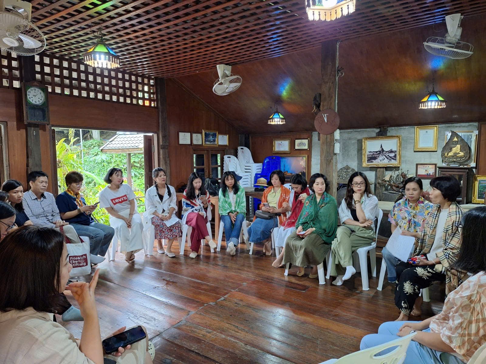 A group of people sitting in chairs Description automatically generated