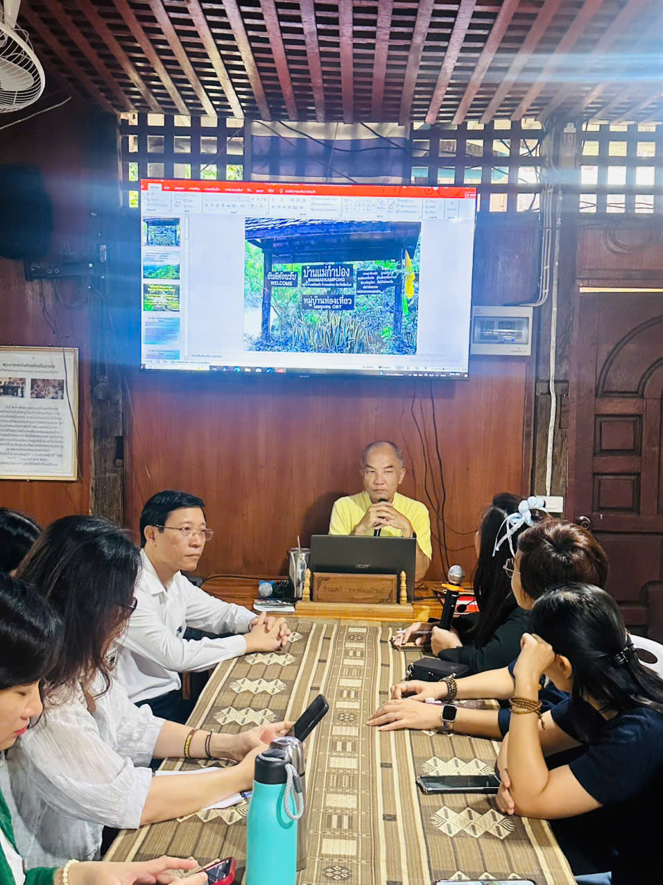 A group of people sitting around a table Description automatically generated