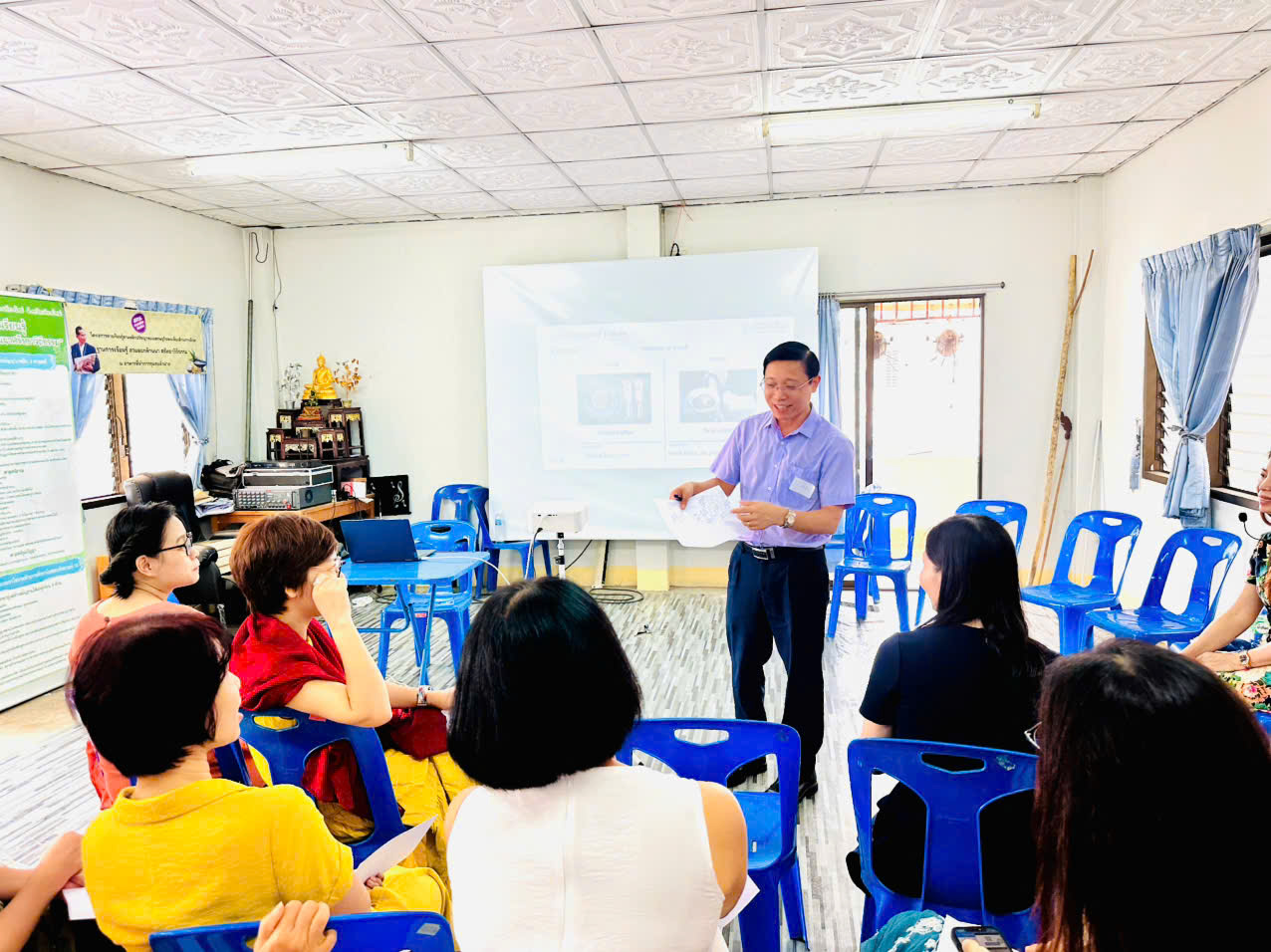 A person standing in front of a group of people Description automatically generated