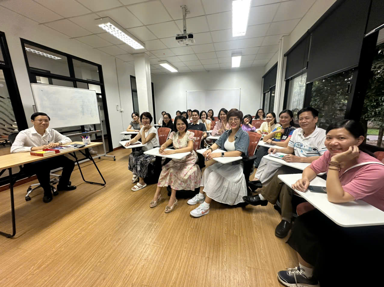 A group of people sitting in a classroom Description automatically generated