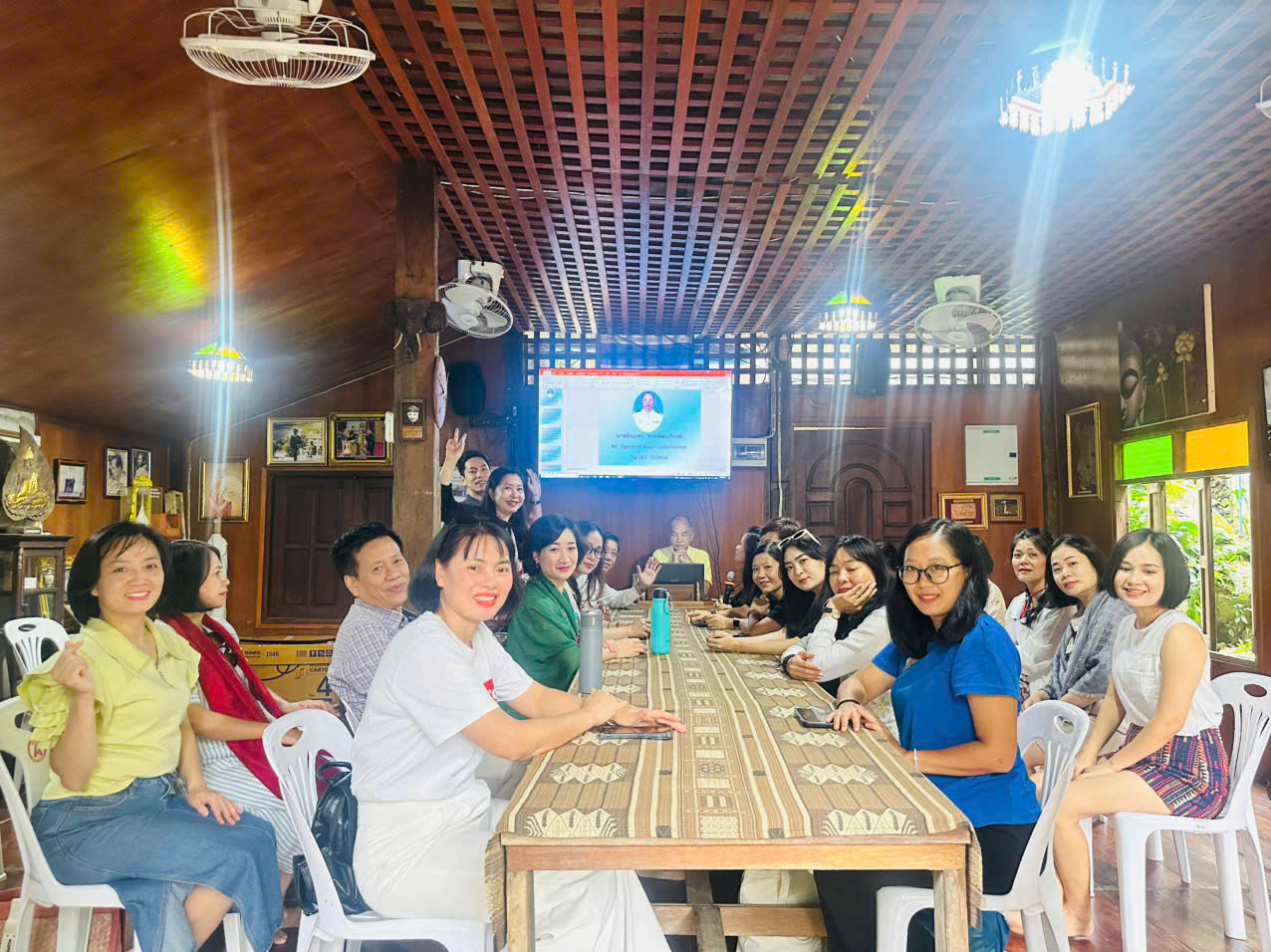 A group of people sitting around a table Description automatically generated