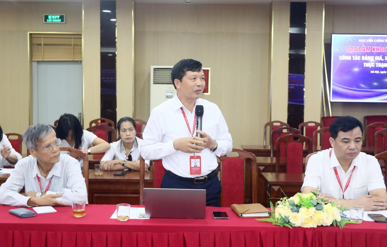 A person standing in front of a table with a microphone Description automatically generated