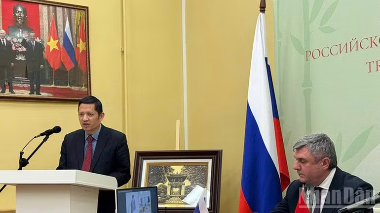 A person standing at a podium with a flag behind him
Description automatically generated