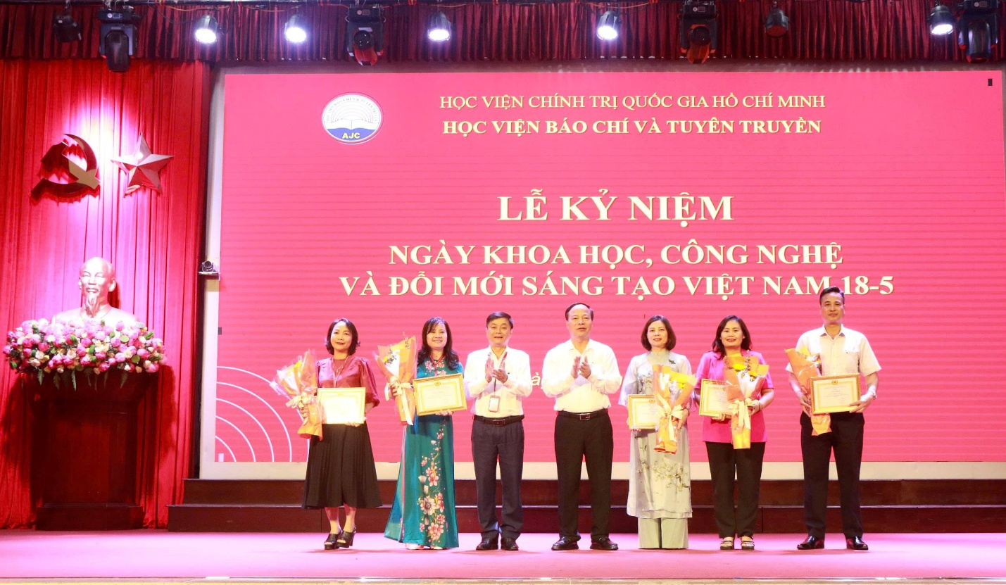 A group of people on a stage Description automatically generated