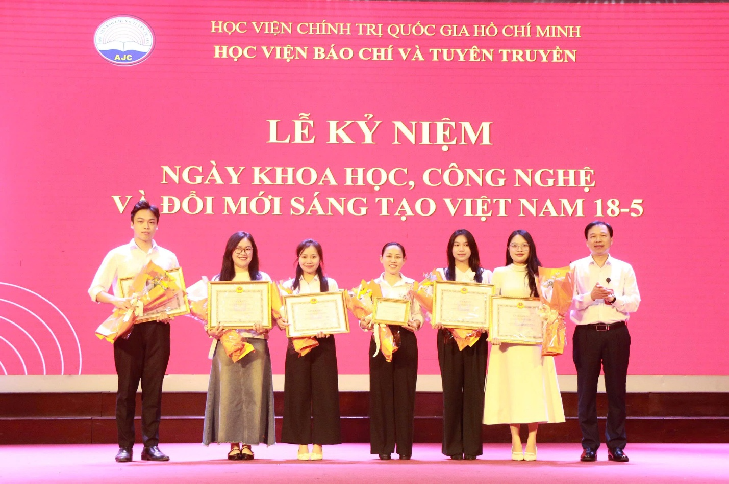 A group of people holding certificates Description automatically generated