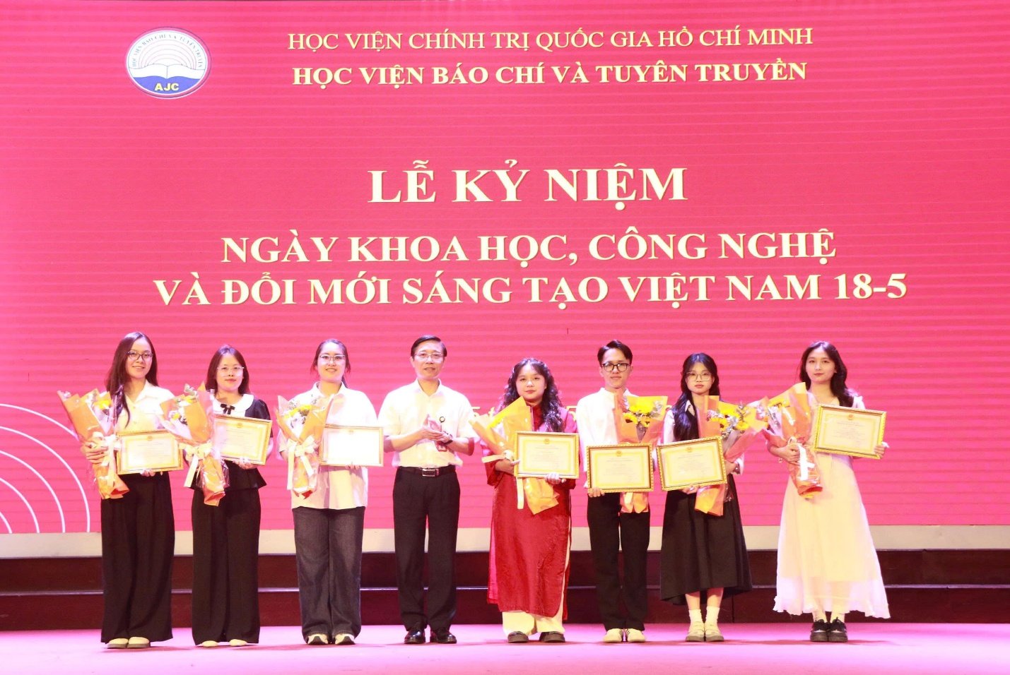 A group of people holding certificates Description automatically generated