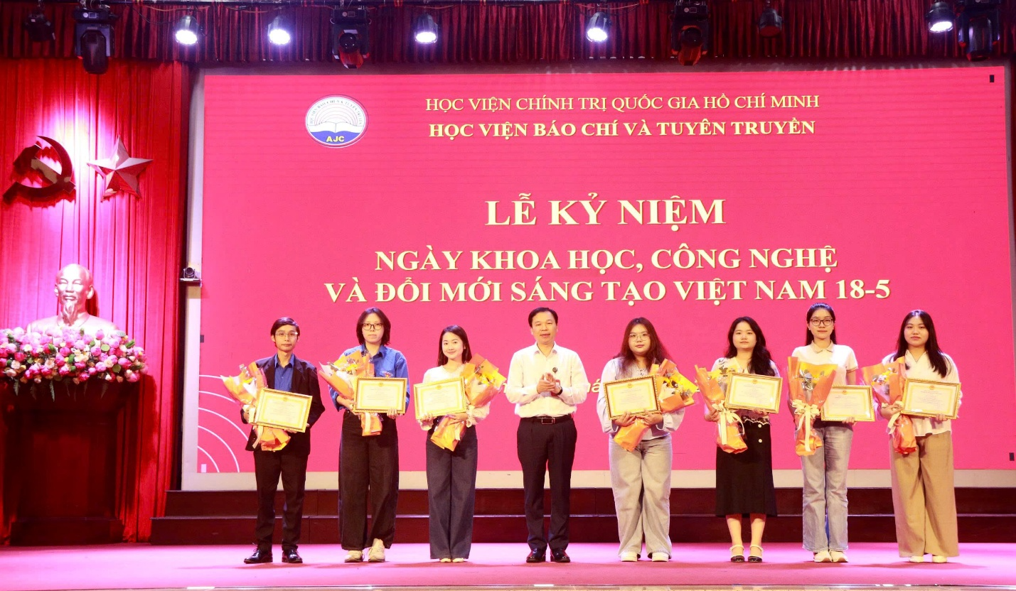 A group of people on a stage holding musical instruments Description automatically generated