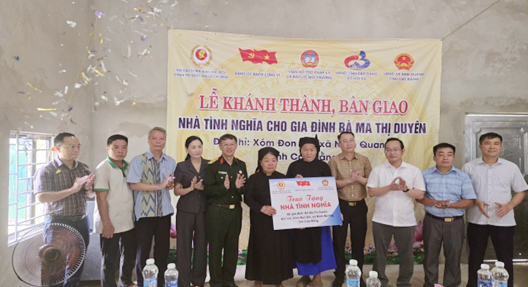 A group of people standing in front of a banner Description automatically generated